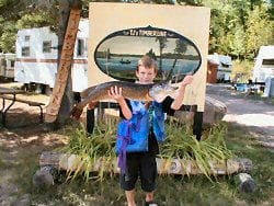 Boy holding up fish