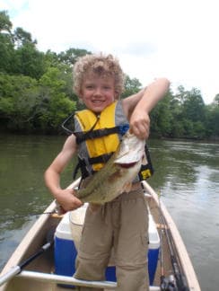 Boy holding up fish